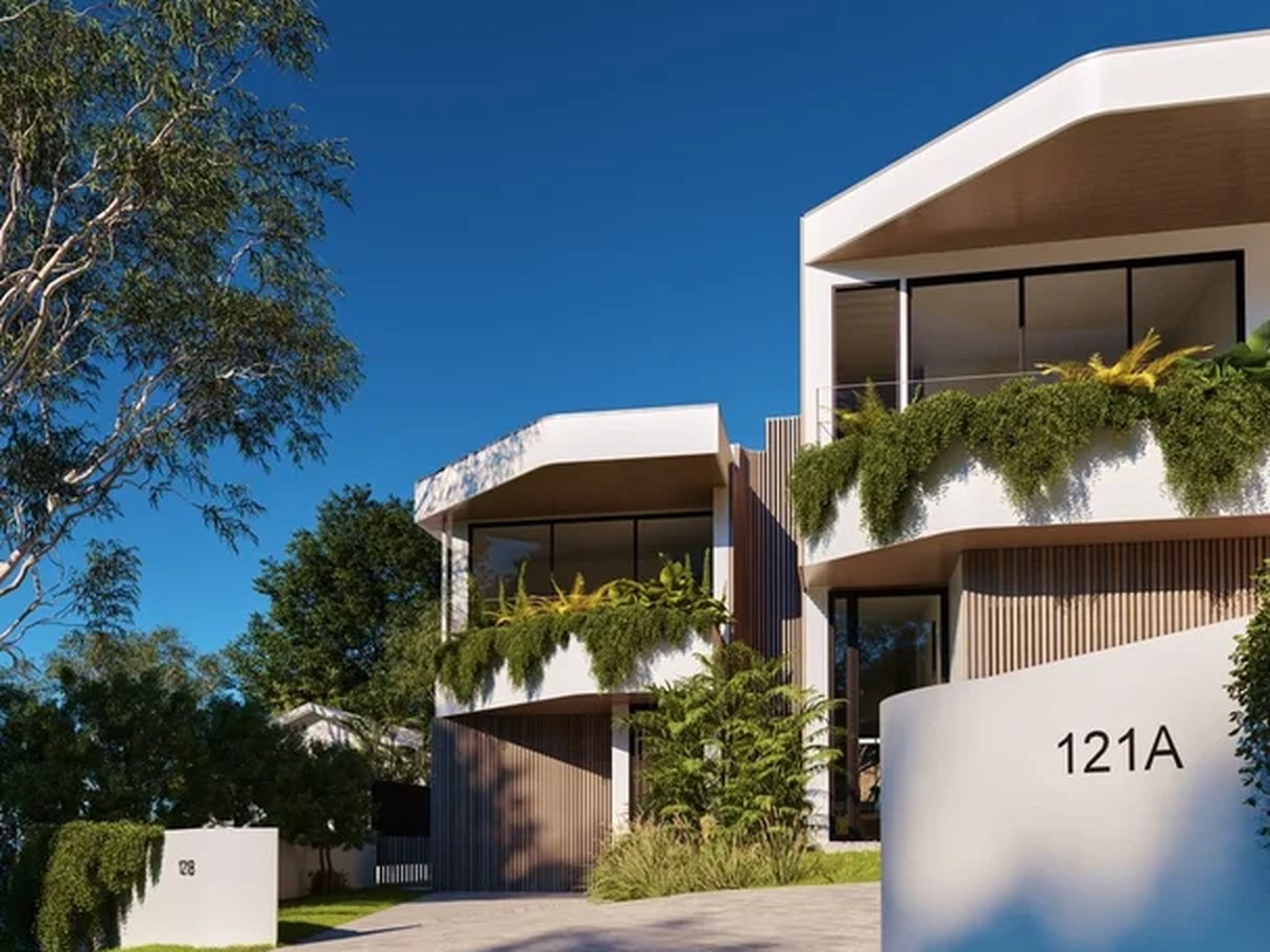 Architect-designed duplex development at dusk — a project managed by Go Build Group