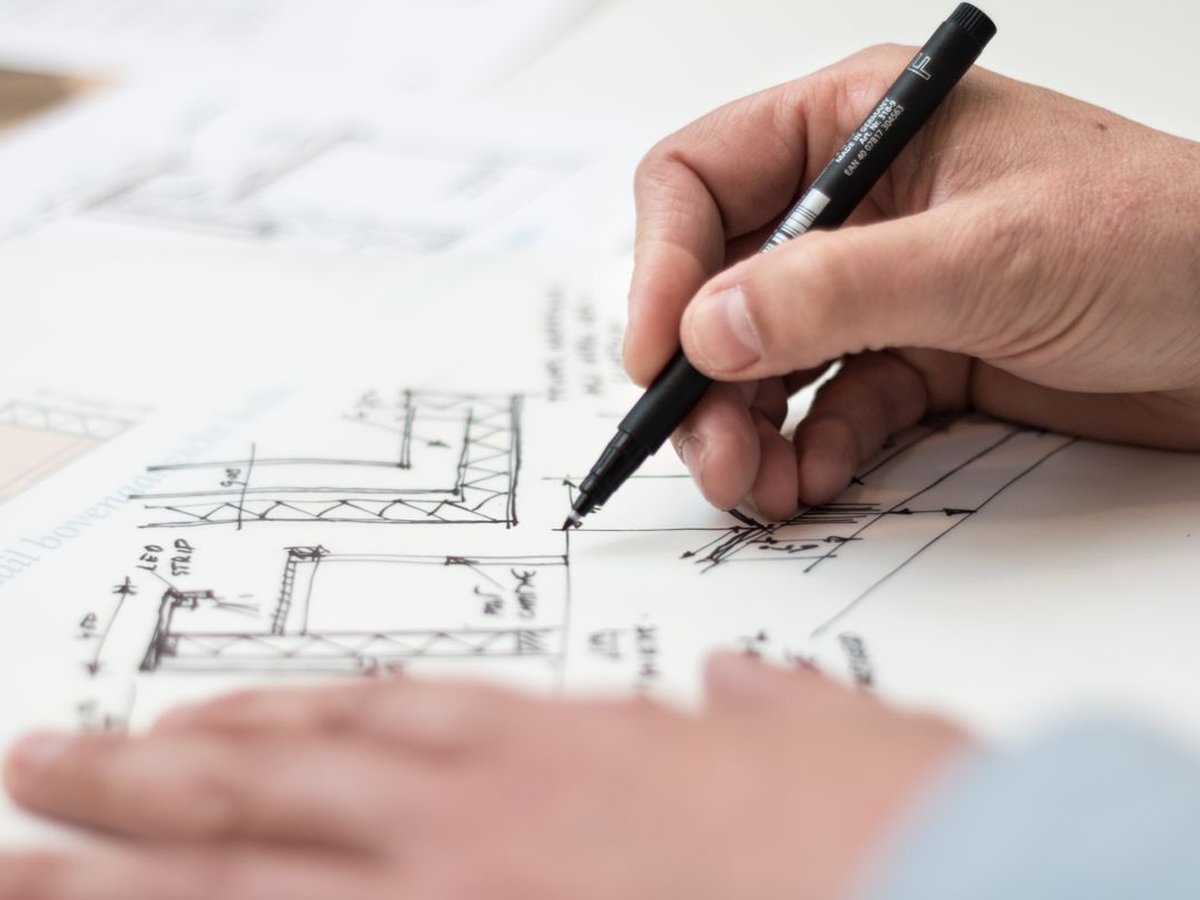 Hand drafting construction details on architectural plans